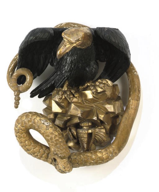 A LATE REGENCY BLACK PAINTED AND CARVED GILTWOOD PINE EAGLE CRESTING