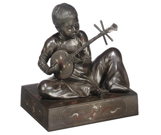 A JAPANESE BRONZE FIGURE OF A YOUNG BOY MUSICIAN