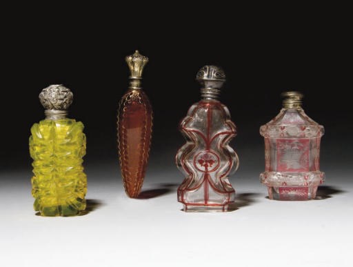 QUATRE FLACONS A PARFUM EN VERRE DE BOHEME ET UN BOUCHON EN LIEGE A MONTURE EN ARGENT ET VERMEIL DU XIXEME SIECLE