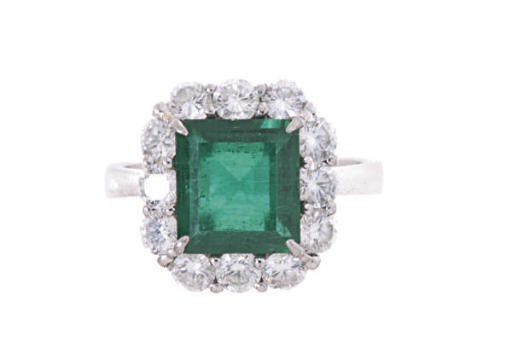 AN EMERALD, DIAMOND AND PLATINUM RING