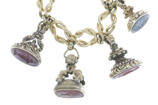 A MULTI-GEM AND 18K GOLD INTAGLIO CHARM BRACELET