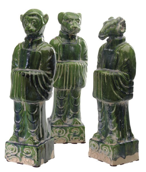 A GROUP OF TWELVE MING STYLE GREEN-GLAZED FIGURES OF THE ZODIAC