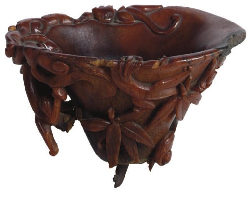 A CHINESE RHINOCEROS HORN CUP CARVED WITH DRAGONS,**