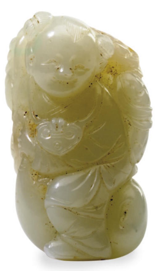 A CHINESE JADE OF A BOY RIDING A GOURD,