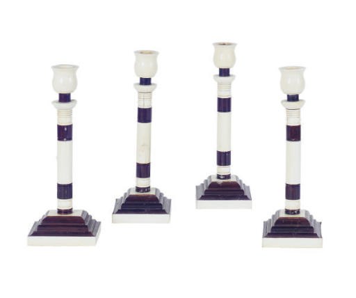 A SET OF FOUR IVORY AND STAINED WOOD CANDLESTICKS**,