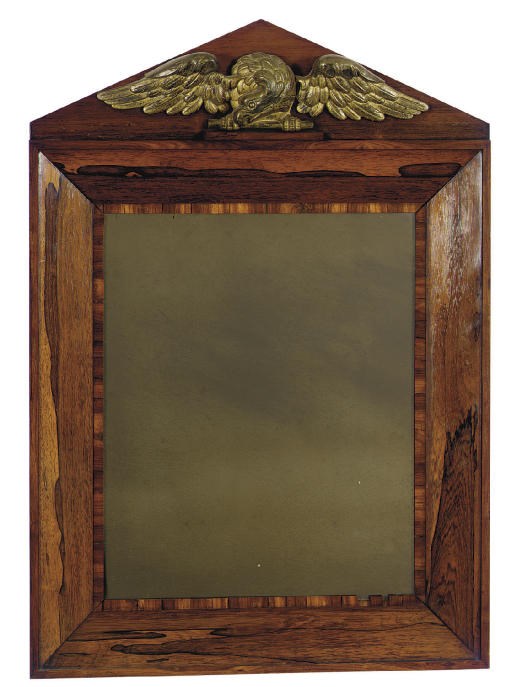 A CONTINENTAL GILT-METAL EAGLE MOUNTED ROSEWOOD MIRROR**,