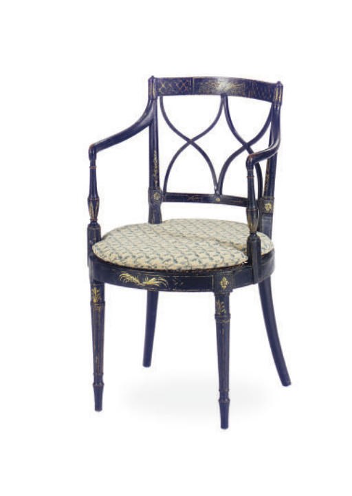 A REGENCY EBONIZED, PARCEL-GILT AND CANED OPEN ARMCHAIR,
