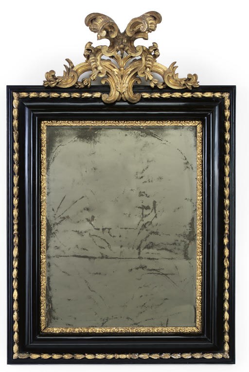 AN ITALIAN EBONISED PEARWOOD AND GILTWOOD MIRROR