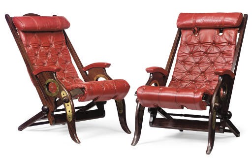 A PAIR OF BRASS-MOUNTED STAINED MAHOGANY RECLINING ARMCHAIRS