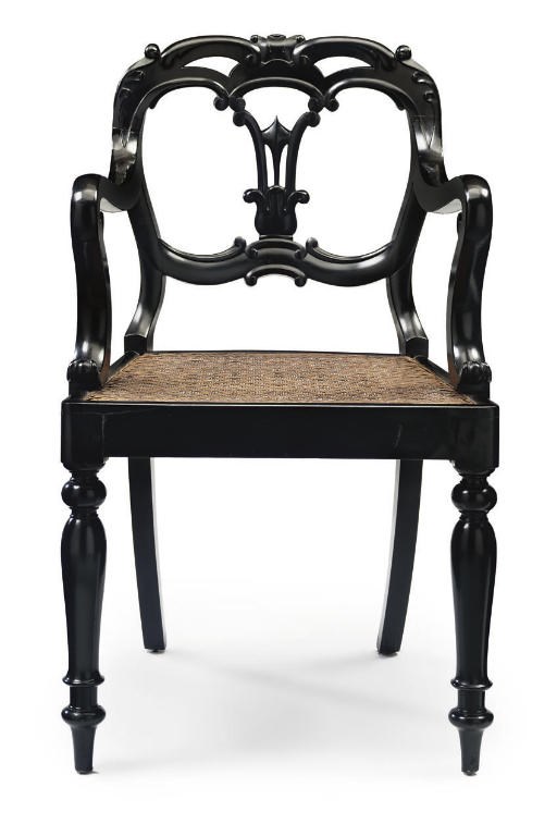 AN ANGLO-INDIAN EBONISED OPEN ARMCHAIR
