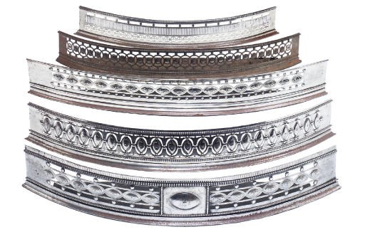 A COLLECTION OF FIVE GEORGE III STEEL BOW-FRONT FENDERS