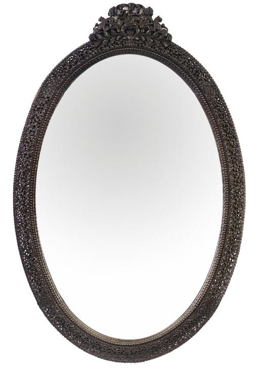 AN INDIAN HARDWOOD OVAL MIRROR