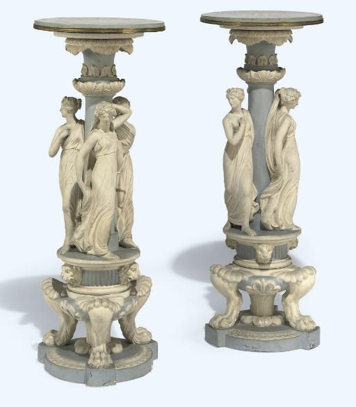 A PAIR OF REGENCY PAINTED PLASTER TORCHERES