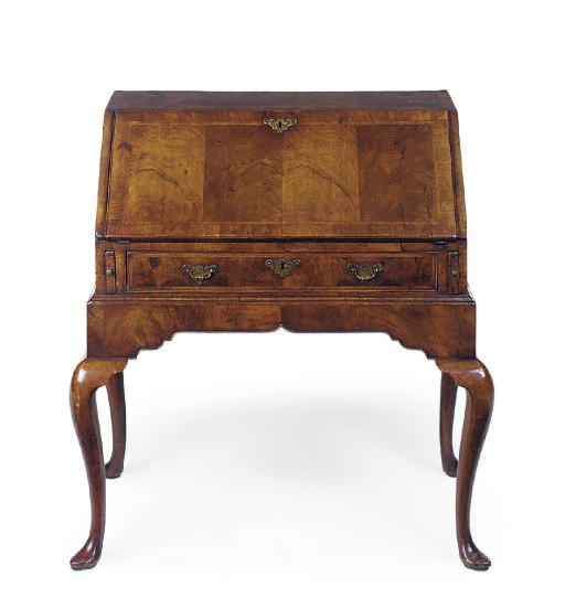 A WALNUT AND FEATHER STRUNG BUREAU ON STAND