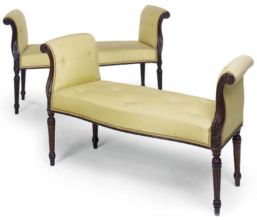 A PAIR OF MAHOGANY AND UPHOLSTERED WINDOW SEATS