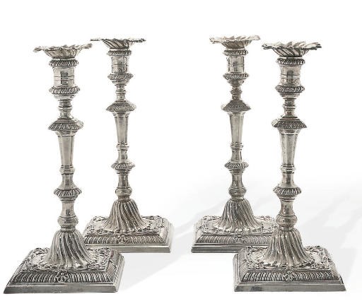 A SET OF FOUR GEORGE III SILVER CAST CANDLESTICKS
