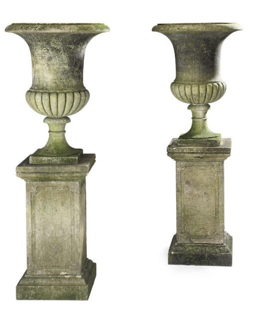 A PAIR OF LIMESTONE CAMPANA URNS AND PEDESTALS