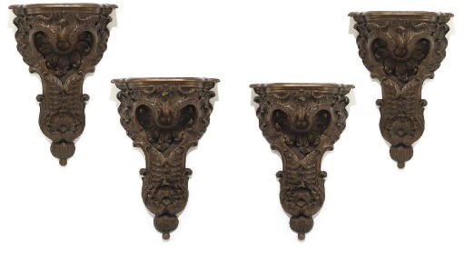A SET OF FOUR ITALIAN WALNUT WALL BRACKETS