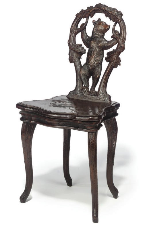 A SWISS 'BLACK FOREST' CARVED WOOD MUSICAL CHAIR