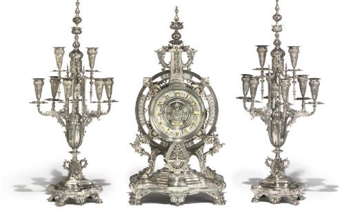 A FRENCH SILVERED WHITE METAL CLOCK AND GARNITURE