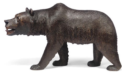 A SWISS 'BLACK FOREST' CARVED WOOD MODEL OF A STROLLING BEAR