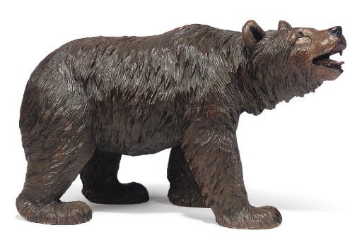 A SWISS 'BLACK FOREST' CARVED WOOD MODEL OF A STROLLING BEAR