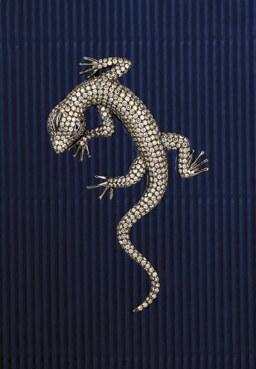 A coloured diamond lizard brooch