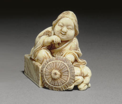 An Ivory Netsuke and Two Wood and Ivory Netsuke**