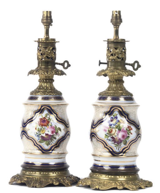 A PAIR OF LATE VICTORIAN POLYCHROME DECORATED PORCELAIN AND GILT BRASS TABLE LAMPS