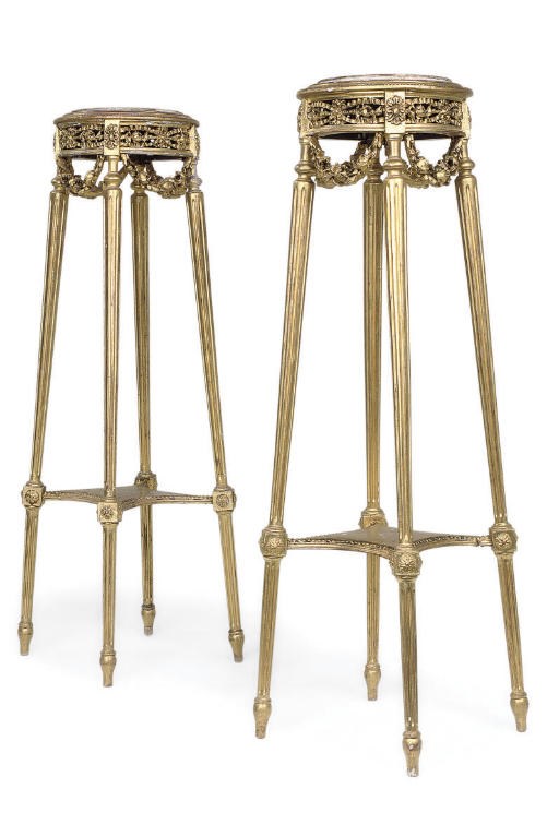 A PAIR OF GILTWOOD AND COMPOSITION TORCHERES