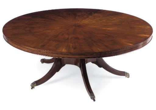 A MAHOGANY CIRCULAR EXTENDING DINING TABLE