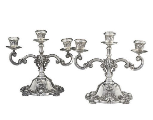 A PAIR OF PORTUGUESE METALWARE THREE-LIGHT CANDELABRA