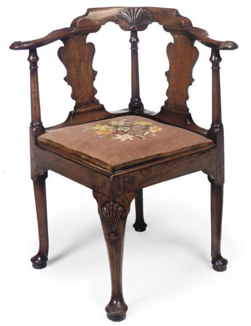 A GEORGE II WALNUT AND BEECH CORNER ARMCHAIR