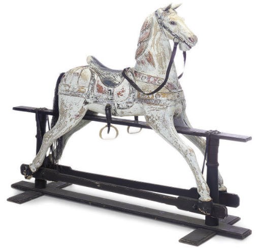 A PAINTED CARVED WOOD ROCKING HORSE