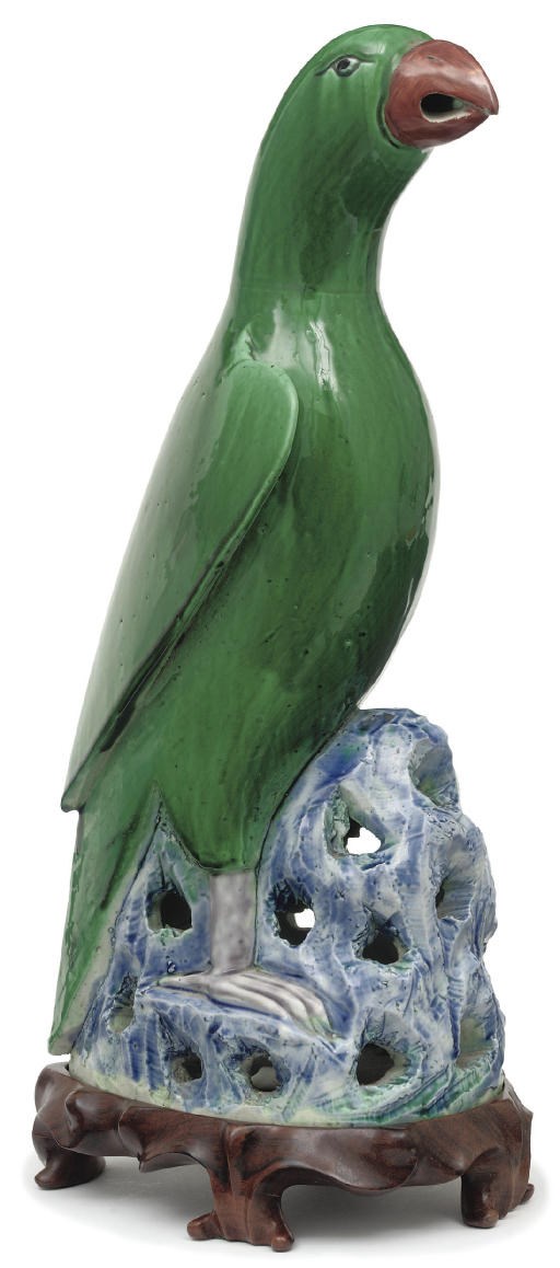 A green glazed model of a parrot