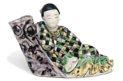 A famille verte biscuit model of a sleeping lady
