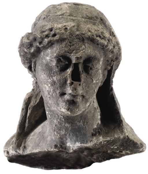 A CARVED STONE FRAGMENTARY HEAD OF A CLASSICAL MAIDEN