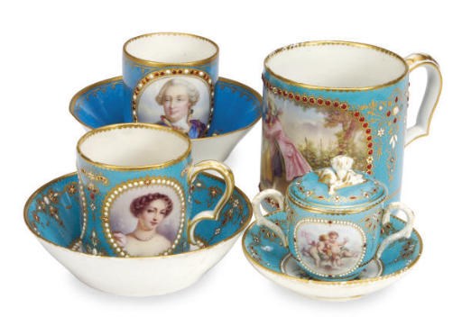 TWO SIMILAR SÈVRES STYLE 'JEWELLED' TURQUOISE-GROUND PORCELAIN CUPS AND SAUCERS, A 'GOBELET LITRON' AND A PORCELAIN CHOCOLATE CUP, COVER AND SAUCER,