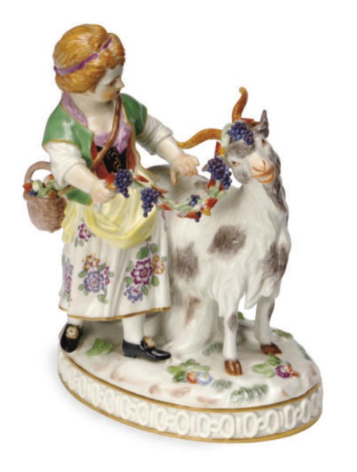 A GERMAN PORCELAIN GROUP OF A YOUNG GOATHERD GARLANDING A GOAT WITH A GRAPEVINE,