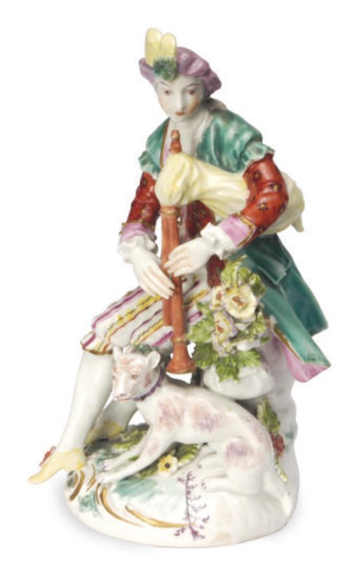 AN ENGLISH FIGURE OF A SHEPHERD PLAYING PIPES,