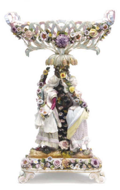 A GERMAN PORCELAIN RETICULATED BASKET ON TREFOIL STAND,