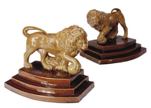 A PAIR OF STAFFORSHIRE LEAD-GLAZED MODELS OF LIONS,