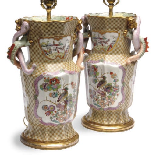 A PAIR OF ENGLISH EARTHENWARE CHINOISSERIE STYLE YELLOW GROUND VASES MOUNTED AS LAMPS WITH ENTWINED DRAGON AND SNAKE-FORM HANDLES,