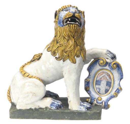 A FRENCH TIN-GLAZED EARTHENWARE MODEL OF A HERALDIC LION,