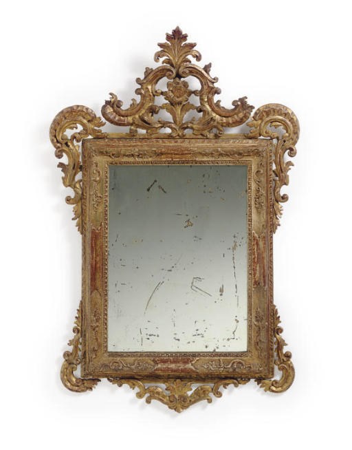 AN ITALIAN ROCOCO GILTWOOD MIRROR,