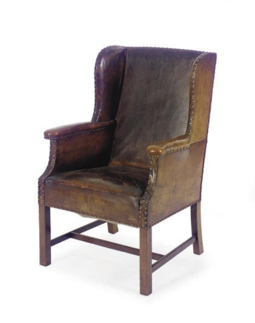 AN ENGLISH MAHOGANY AND LEATHER UPHOLSTERED WINGBACK ARMCHAIR,