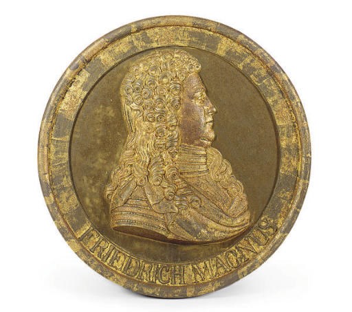 A CIRCULAR GILT-CAST IRON PLAQUE OF FRIEDRICH MAGNUS