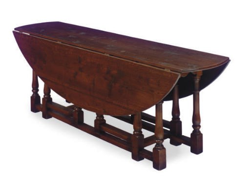 AN OAK GATE-LEG DINING TABLE,