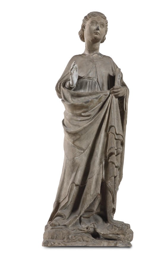 A CARVED STONE FIGURE OF A FEMALE SAINT