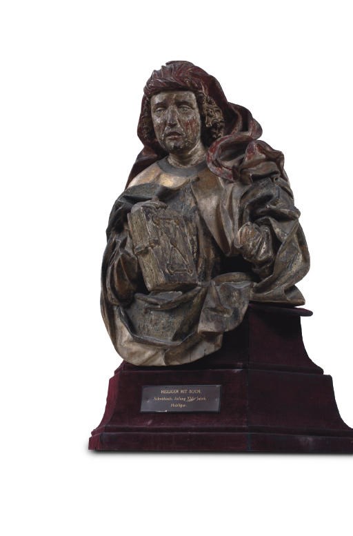 A POLYCHROME PARCEL-GILT AND SILVERED CARVED LIMEWOOD BUST OF A MALE SAINT